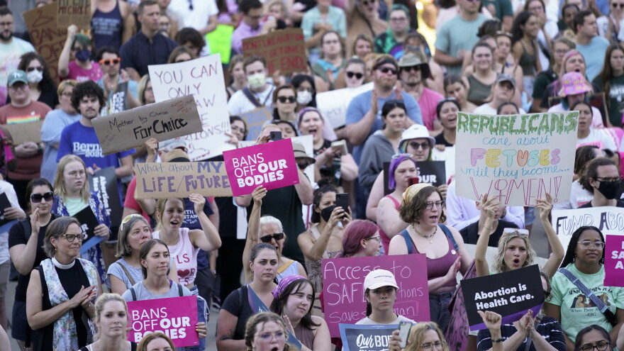 Detail picture of a dense crowd of protestors hold signs supporting abortion rights.