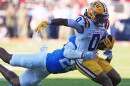 FILE - LSU wide receiver Zavion Thomas (0) is tackled by Mississippi linebacker Tahj Chambers (26) during the second half of an NCAA college football game in Oxford, Miss., Sept. 27, 2025. (AP Photo/Rogelio V. Solis, File)
