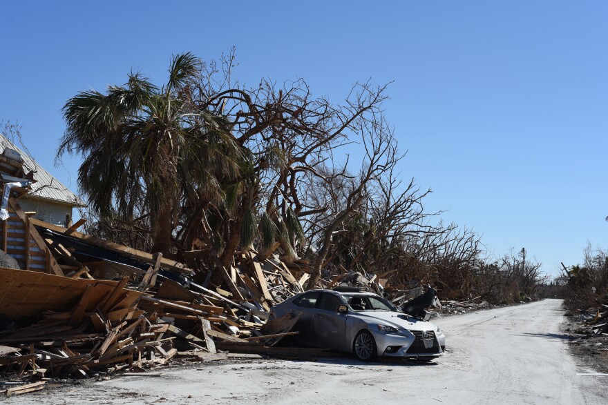  An abandoned Lexus sits in the middle of West Gulf Drive on Sanibel, Saturday, Oct. 8, 2022. A dog statue and toaster sit atop it. 