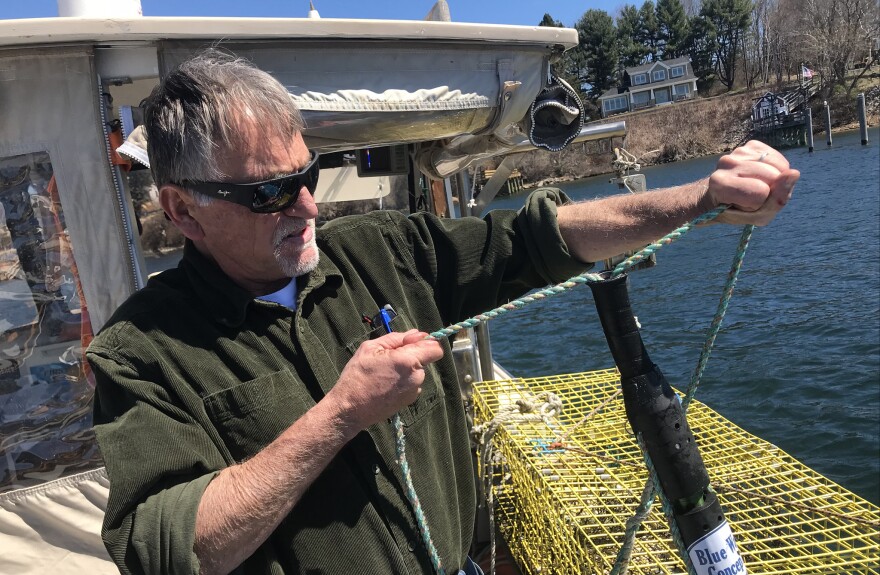 Ben Brickett tests out his time tension line cutter in the Piscataqua river