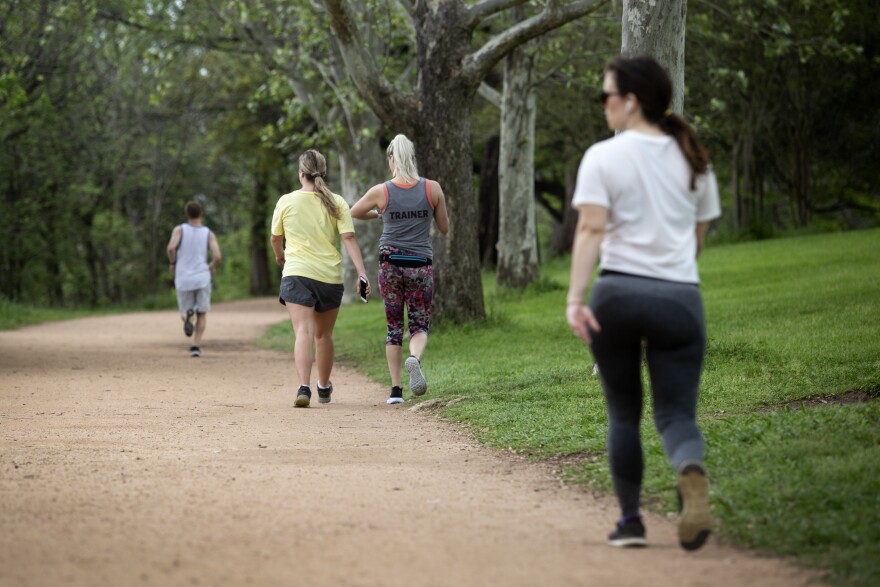 People run and walk near Lady Bird Lake on March 23. 