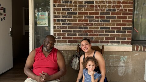 Keith Francis, Maritka Veach and her child outside the Kingston Motel.