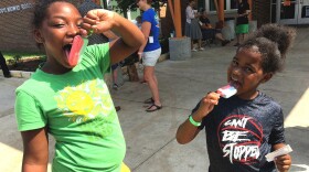Diamond Compton, 9 and brother Josiah Anderson, 6 enjoy ice cream at the Walnut Hill Recreation Center shelter. They evacuated to North Texas from Port Arthur. (Courtney Collins/KERA)