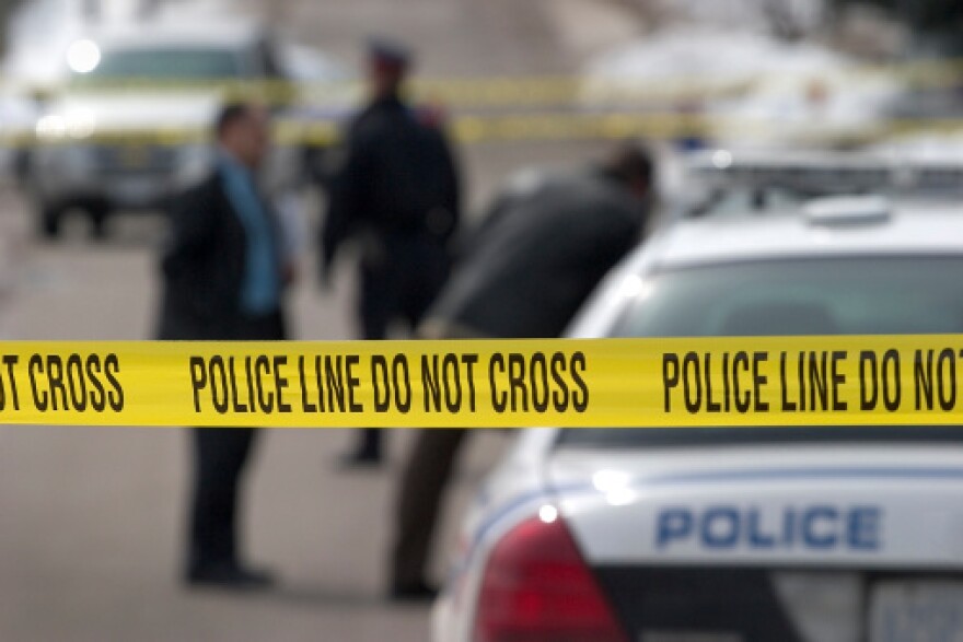 crime scene. Detectives and officer in background. 