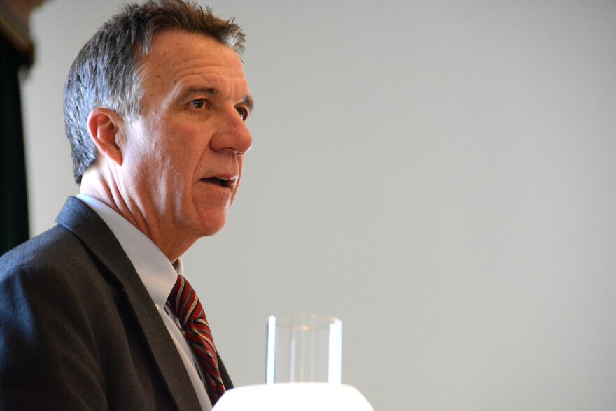 Gov. Phil Scott in a dark suit and red striped tie