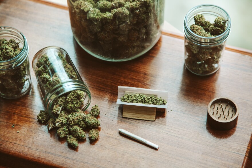 A table with glass jars filled with pot