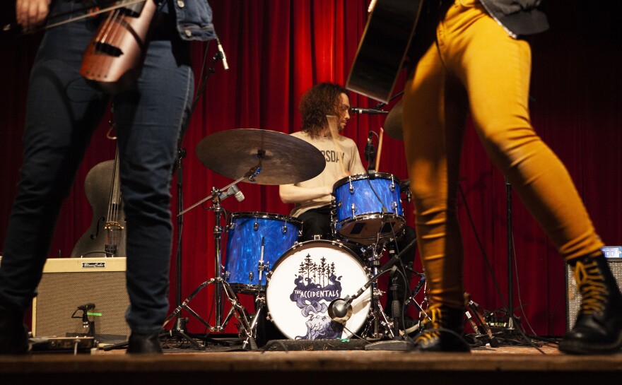 Michael Dause plays the drums behind The Accidentals' front-women, Katie Larson and Sav Buist on Thursday night in Leland.