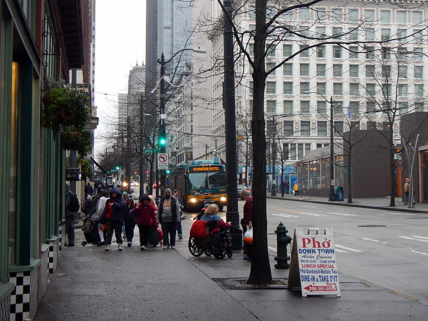 A line of homeless people outside a shelter in downtown Seattle.