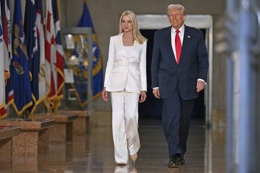 President Donald Trump arrives with Attorney General Pam Bondi to speak at the Justice Department in Washington, Friday, March 14, 2025.