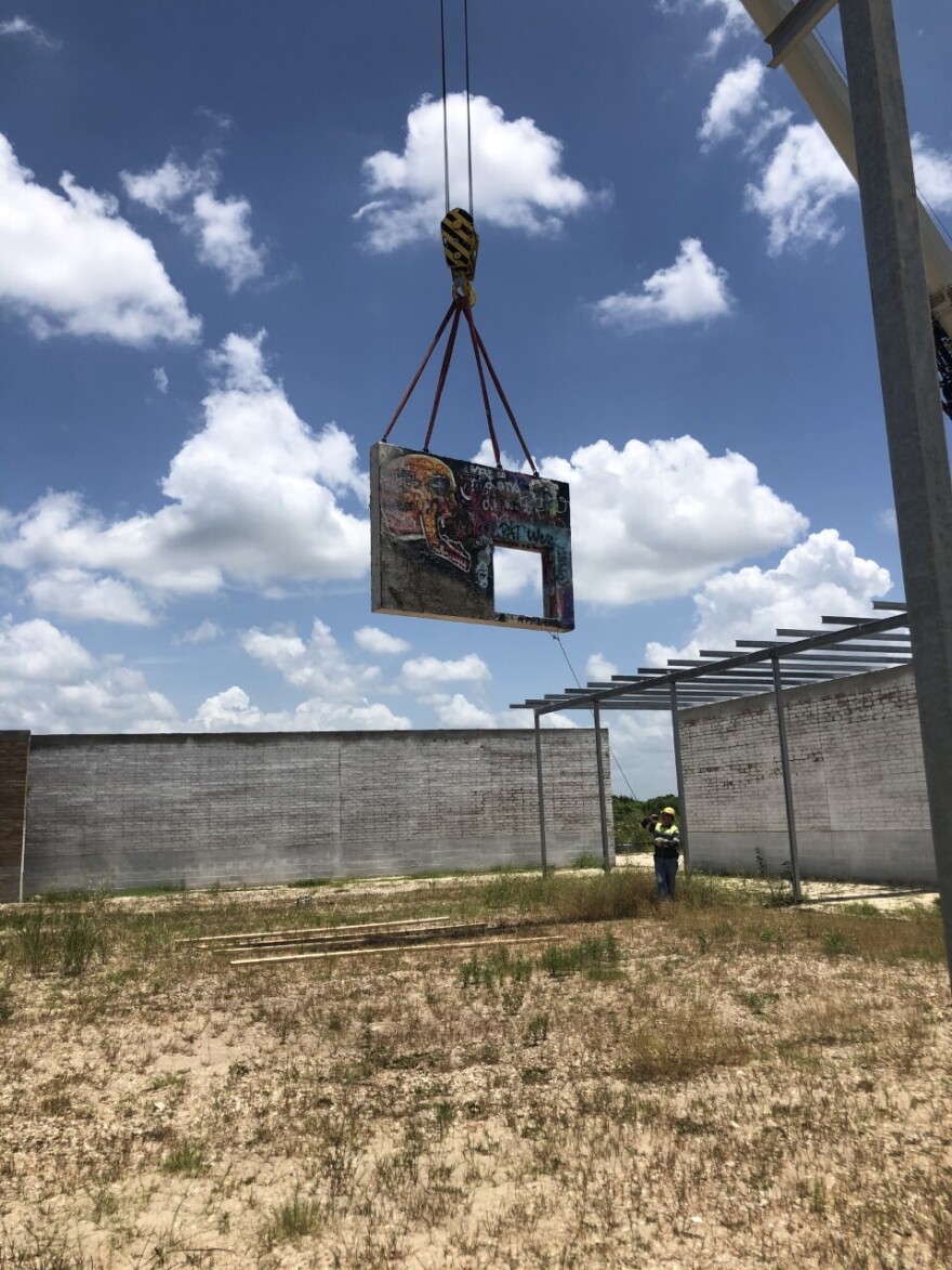 One of the original walls from the Castle Hill park is moved to the new location near the airport.
