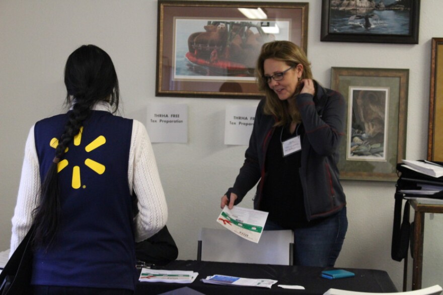 A Tlingit-Haida Regional Housing Authority staffer assists a Wal-Mart associate at the job fair. (Photo by Elizabeth Jenkins/KTOO)