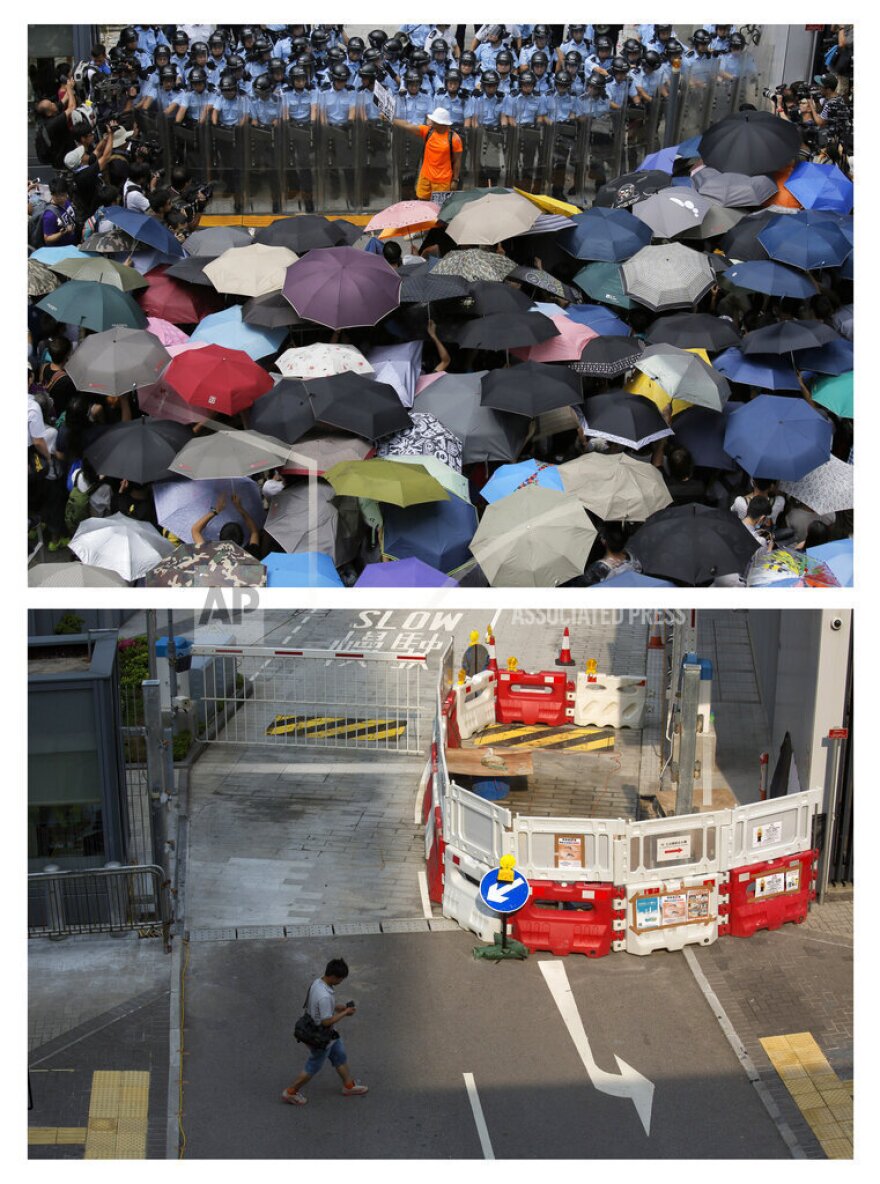 This combination of Sept. 27, 2014 (top) and Sept. 26, 2015 photos shows a protester holding a placard that reads "Occupy Central" between police and protesters outside the government headquarters during the Umbrella Movement in Hong Kong, and the same area almost a year later.