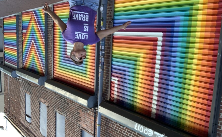 Lisa Marie Thalhammer poses last summer in front of her 2017 <em>LOVE</em> mural in D.C.'s Blagden Alley.