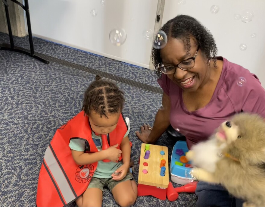 Kai Johnson, shown with her grandson TJ at the Orlando Public Library, said the Orange County Library System boosts literacy. "They're teaching about the love of reading," she said, "and how it can expand your world."