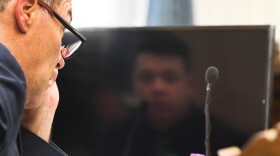 Kyle Rittenhouse is reflected in the computer screen in front of Defense Attorney Mark Richards as Richards cross-examines a witness during the Kyle Rittenhouse trial in Kenosha Circuit Court Tuesday November 2, 2021.