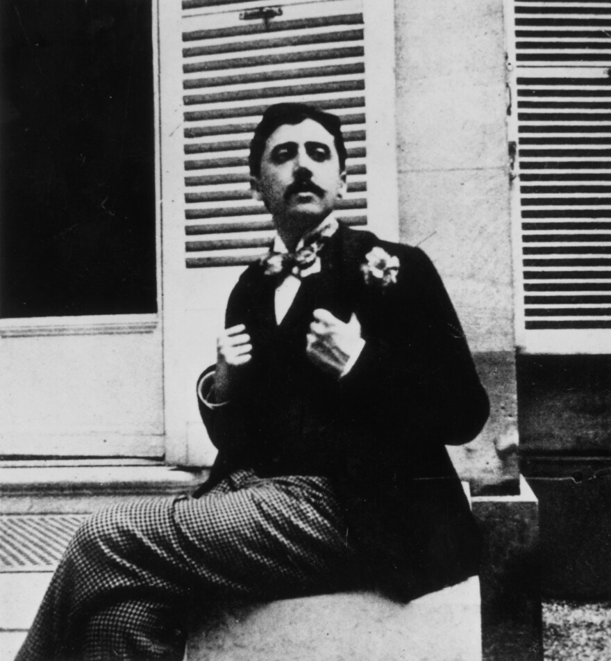 In this photograph, taken circa 1910, Marcel Proust poses outside a window. The image places Proust roughly a few years before the publication of the first volume of his masterpiece, <em>In Search of Lost Time</em>.