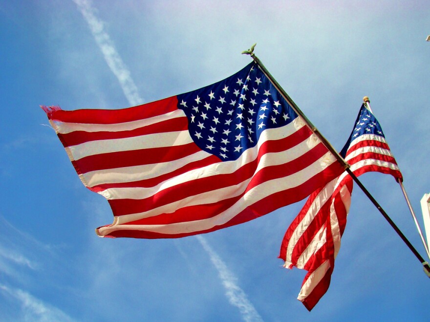 Two American flags wave in the wind