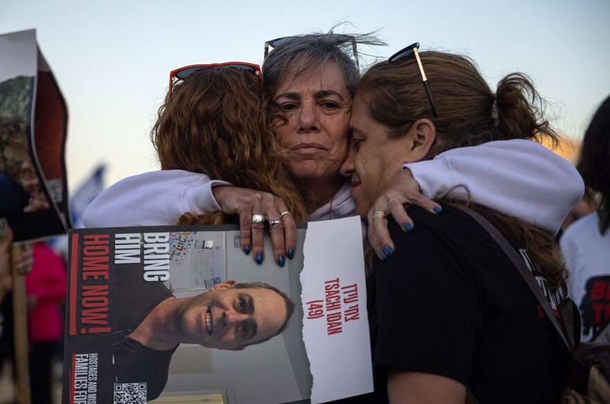 Einat Ofir embraces her cousins, Ronit Dvir and Karni Peleg, after a ceremony at the site of the former police station in Sderot, Israel on Feb. 28. The families of the Israeli hostages held a four-day march to keep attention focused on the plight of their loved ones still in captivity and to pressure the Israeli government to secure a deal that would release them.