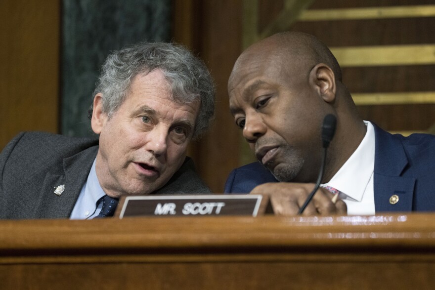 two men lean into to talk to each other