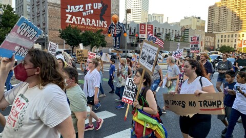 Protesters march down Poydras Street in New Orleans on Sept. 9, 2025, during a demonstration against President Donald Trump's suggestion of deploying National Guard troops to the city.
