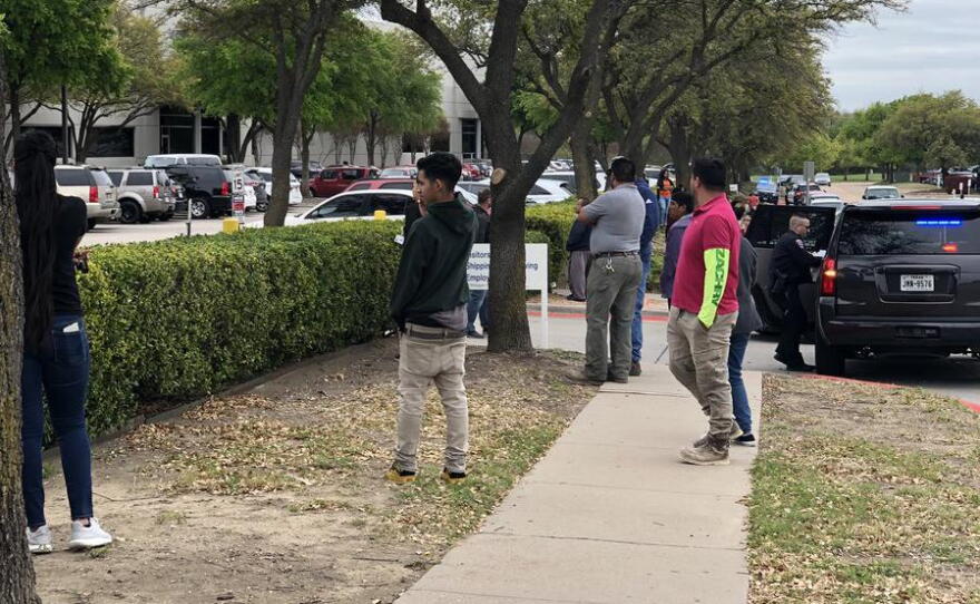  Family of employees inside CVE Technology Group in Allen gathered outside the building, where the ICE operation took place.