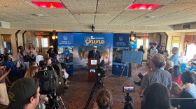 Lt. Governor Billy Nungesser stands behind a podium as he speaks to a capacity crowd aboard the Creole Queen.