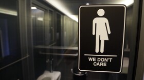 FILE - This Thursday, May 12, 2016, file photo, shows signage outside a restroom at 21c Museum Hotel in Durham, N.C. North Carolina is in a legal battle over a state law that requires transgender people to use the public restroom matching the sex on their