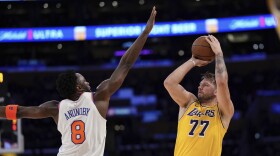 Los Angeles Lakers guard Luka Doncic, right, shoots as New York Knicks forward OG Anunoby defends during the first half of an NBA basketball game Thursday, March 6, 2025, in Los Angeles. (AP Photo/Mark J. Terrill)
