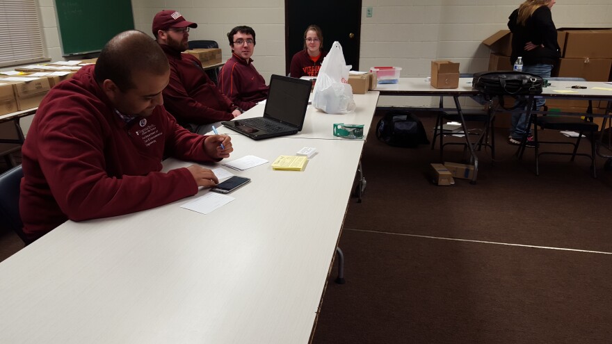 Flint residents and Virginia Tech students distribute and collect water sampling kits in Flint last month.