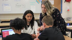 Middle school teacher Melanie Franklin helps Sophia Dressner as she plays an online vocabulary game on June 16, 2022. Franklin says games like these help keep students engaged during summer school. (Katie Anastas/Alaska Public Media)