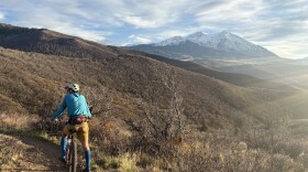 A mountain biker pauses near the top of the Crown, a popular recreation area near Carbondale, on Oct. 25, 2025. Like most of the trail systems throughout the Roaring Fork Valley, the Crown’s hills are rangelands — a landscape dominated by grasses and shrubs.