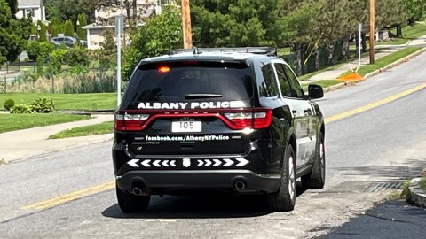 An Albany Police Department SUV patrols a city street.