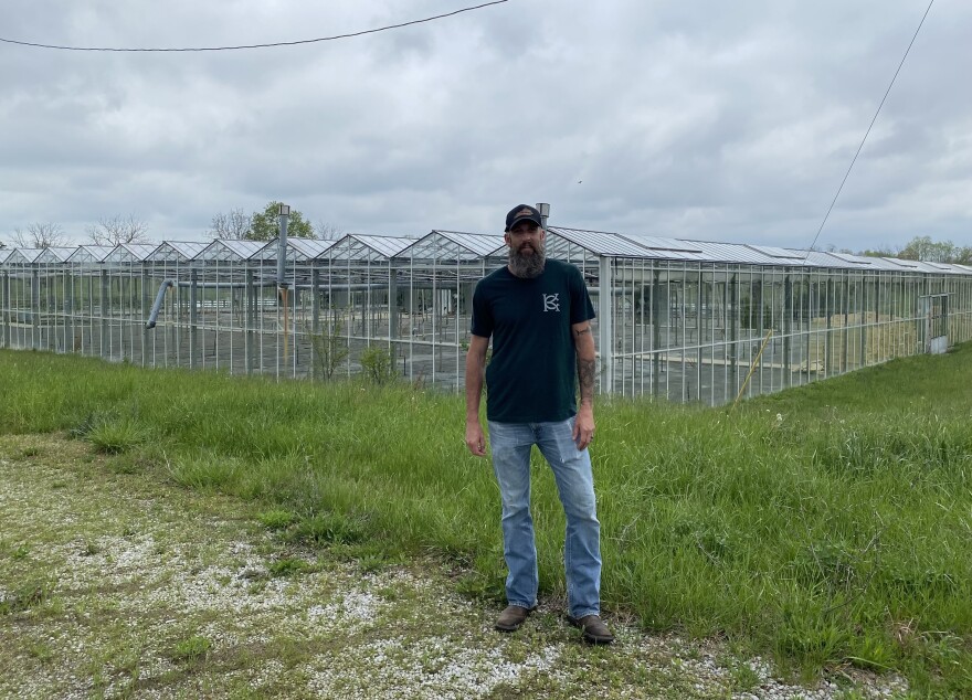 Michael Adair stands in front of a large greenhouse in April on his farm in Paris, Kentucky, where he hoped to have grown medical cannabis had he won a state license in the lottery last year.