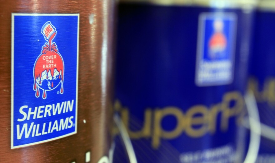 Closeup of cans of paint with a Sherwin Williams logo