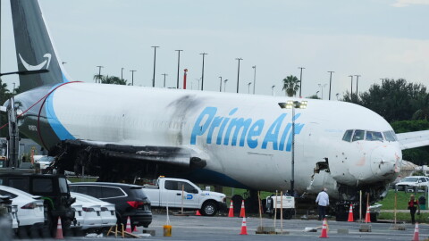 Workers inspect an Amazon cargo plane that overshot a runway four days ago at Miami International Airport, Thursday, Sept. 10, 2026, in Miami.