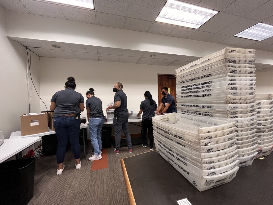 State Election Division staff use a letter opener to sort through primary election ballots
