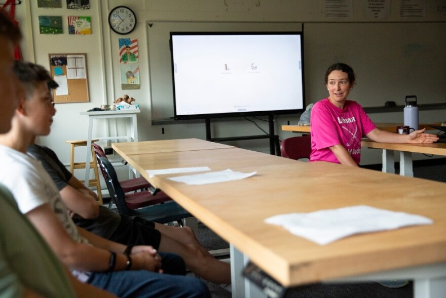 Amanda Valliere, right, talks to students in her civics and economics class during freshman orientation at Lebanon High School in Lebanon, N.H., on Tuesday, Aug. 25, 2026. Valliere told students that one of the first topics they will be discussing in the class is AI, and she asked them to think about their feelings on the subject. (Valley News photo)