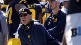 Michigan head coach Jim Harbaugh, front left, watches against Rutgers as analytics assistant Connor Stalions, right, looks on during an NCAA college football game in Ann Arbor, Mich., Sept. 23, 2023. Stalions was suspended by the university last week and is at the center of a sign-stealing scheme that is being investigated by the NCAA. 