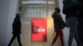 Shoppers walk past a "Sale" sign outside a store at the Easton Town Center Mall in Columbus, Ohio, on Jan. 7.