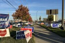 Political signs from both sides line the sidewalk near the early voting center on the final day in Franklin County on Nov. 3, 2024.