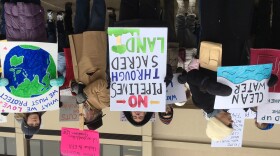 Jacqueline King, center, was among nearly 300 demonstrators at the federal building Thursday.