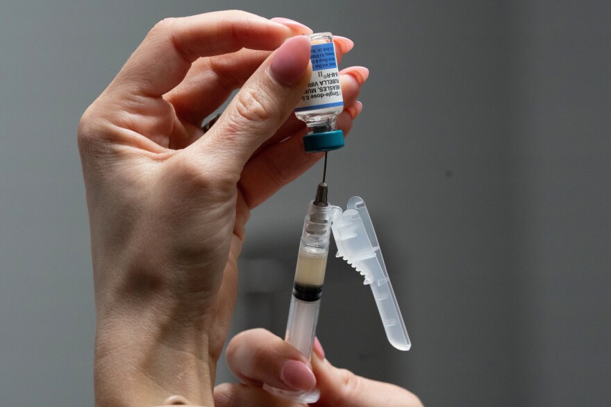 FILE - Lauren Ellenburg, a nurse, prepares a combination measles, mumps and rubella vaccine for a patient at Tiger Pediatrics in Easley, S.C., March 17, 2026. (AP Photo/Mary Conlon, File)