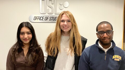 Augustana students Fatima Fqiyah (left) and Rachel Byrne, with Reynard Beschop, director of student activities, at Augie's Office of Student Life on Jan. 13, 2026.