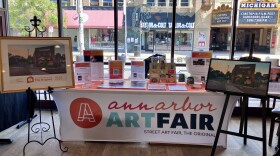 Commemorative posters for the 2026 Ann Arbor Art Fair include Matthew Cornell's "Original" Ann Arbor Street Art Fair featuring Zingerman's Delicatessen