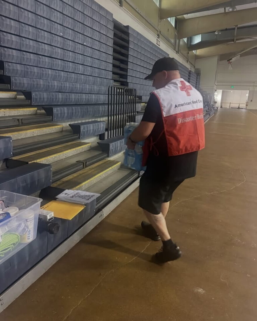 An American Red Cross volunteer gets supplies ready at the Lahaina Civic Center as it opens as a shelter due to a brush fire and power outage in Olowalu.