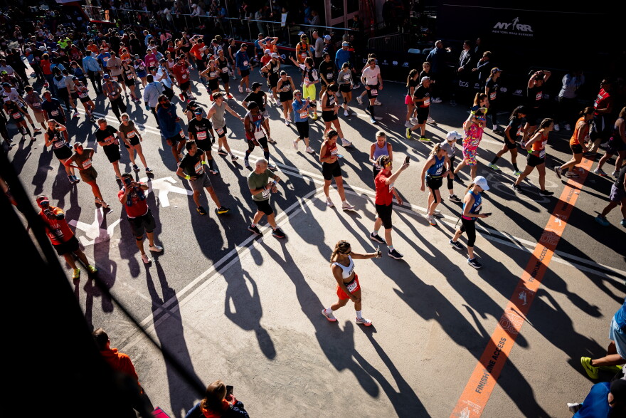 Runners cross the finish line in Central Park at the New York City Marathon, Sunday, Nov. 2, 2025, in New York. (AP Photo/Angelina Katsanis)