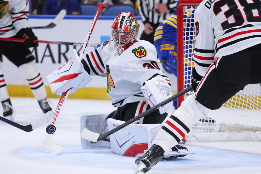 Chicago Blackhawks goaltender Spencer Knight (30) makes a save during the first period of an NHL hockey game agaunst the Buffalo Sabres, Saturday, Oct. 3, 2026, in Buffalo, N.Y. (AP Photo/Jeffrey T. Barnes)