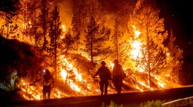 Firefighters burn off vegetation while trying to stop a wildfire called the Bench Fire from spreading in Warm Springs, Ore., on Saturday, July 25, 2026.