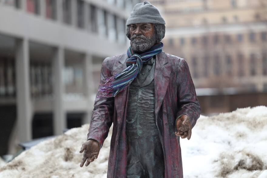 The Frederick Douglass statue on State Street is kept warm with a donated hat and scarf.