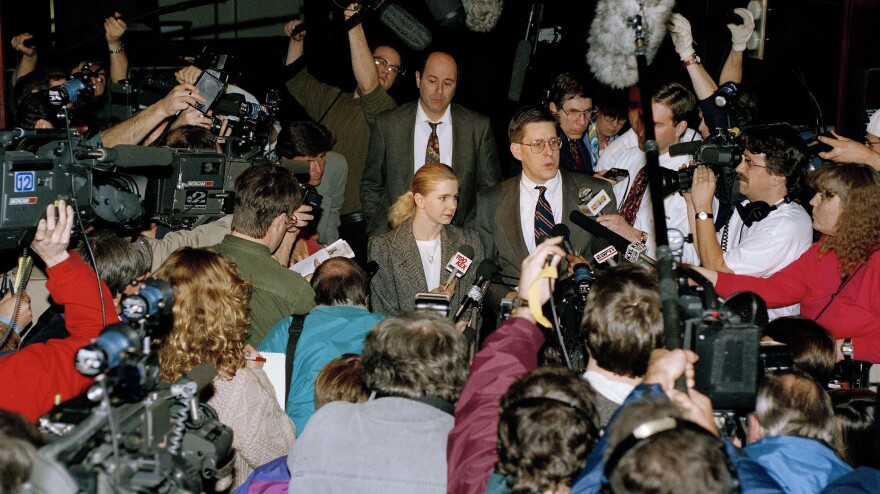 Photographers and reporters beset Harding and her lawyer outside the district attorney's office in Portland, Ore., in 1994, after the attack on Kerrigan.